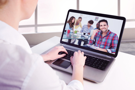 Businesswoman using her laptop against handsome designer sit in his office