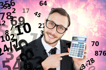 Geeky businessman pointing to calculator  against purple vignetteの写真素材