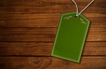 Elegant green and gold tag against overhead of wooden planksの写真素材
