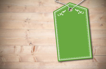 Elegant green tag against bleached wooden planks backgroundの写真素材