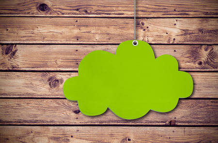 Hanging cloud tag against wooden planks background
