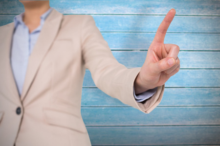 Businesswoman pointing against wooden planksの写真素材