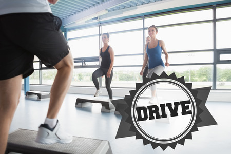 The word drive and trainer stepping with aerobics class against badge