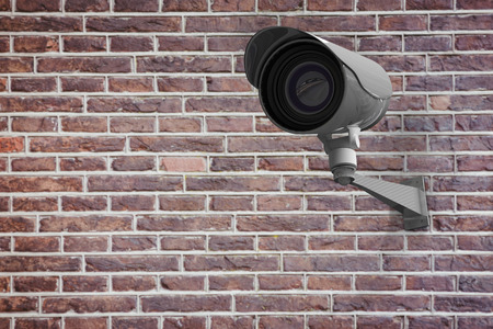 CCTV camera against red brick wallの写真素材