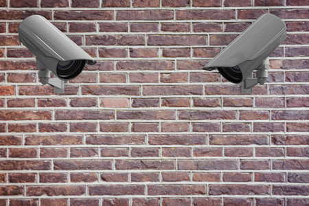 CCTV camera against red brick wallの写真素材