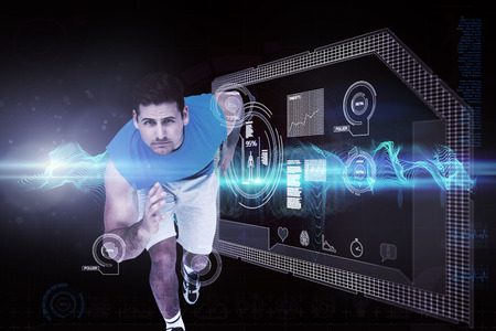 Portrait of a young sporty man running against abstract blue glowing black backgroundの写真素材