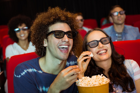 Young friends watching a 3d film at the cinema
