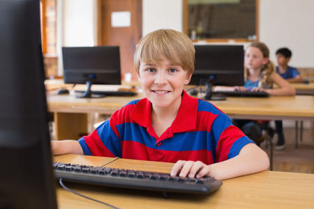 Cute pupil in computer class at the elementary school
