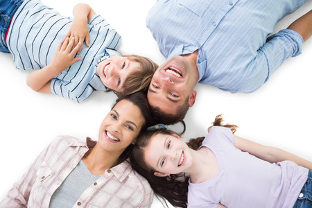 High angle portrait of happy parents and children lying on white backgroundの写真素材