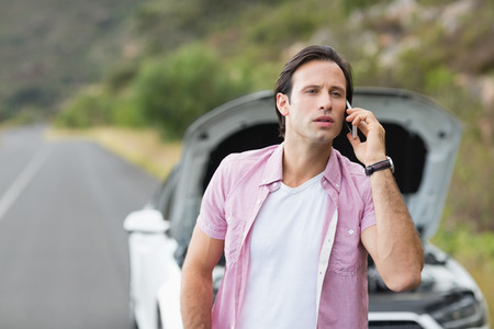 Man after a car breakdown at the side of the roadの写真素材