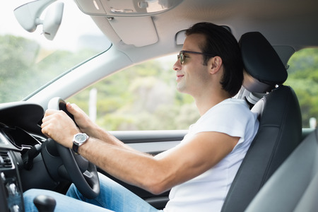 Man driving and smiling in his carの写真素材