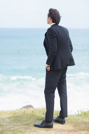 Businessman looking the view at the beachの写真素材