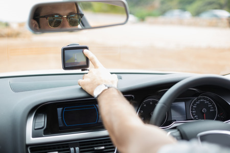 Man using satellite navigation system in his car