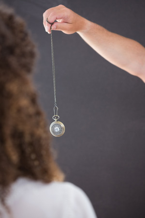 Woman being hypnotized with pendulumの写真素材