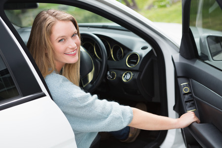 Young woman in the drivers seat in her car