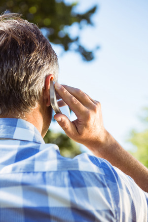 Casual man on the phone on a sunny dayの写真素材