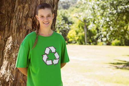 Environmental activist smiling at camera in the park on a sunny day