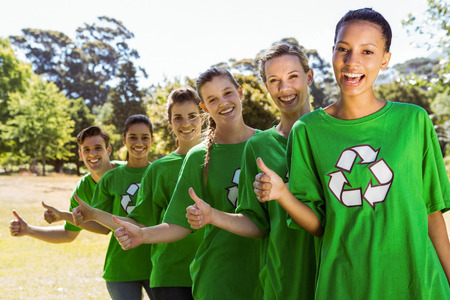 Environmental activists smiling at camera on a sunny dayの写真素材