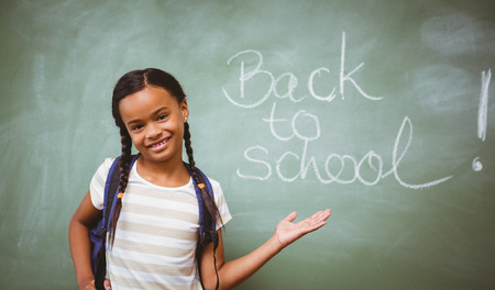 Portrait of cute little girl standing in the classroomの写真素材