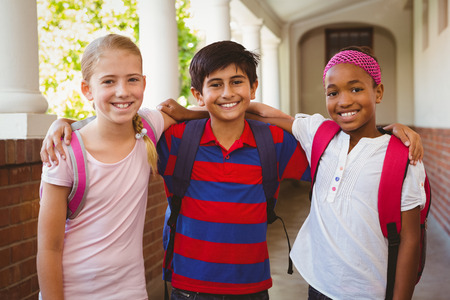 Portrait of smiling little school kids in school corridorの写真素材