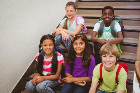 Portrait of children sitting on stairs in the schoolの写真素材