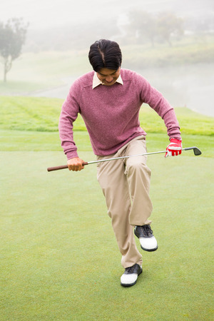 Angry golfer trying to brake his club at the golf courseの写真素材