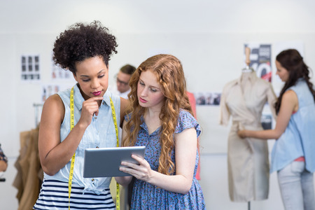 Attractive female fashion designers using digital tablet