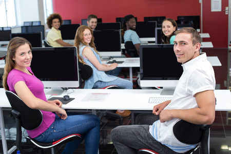 Portrait of smiling students in computer class