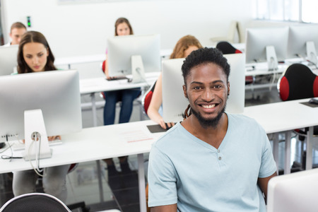 Portrait of smiling students in computer class