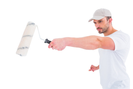Handyman holding paint roller on white background