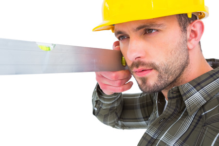 Carpenter using spirit level on white background