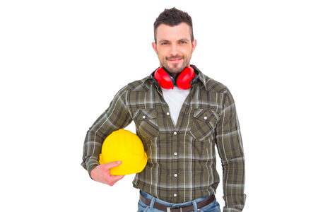 Handyman with earmuffs holding helmet on white background