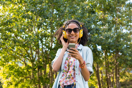 Pretty hipster listening to music on a sunny day