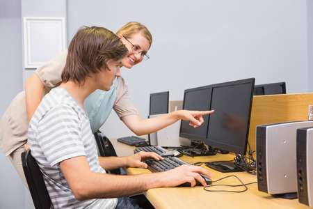 Student working on computer in classroom at the universityの写真素材