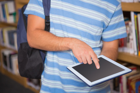 Student using tablet in library at the universityの写真素材