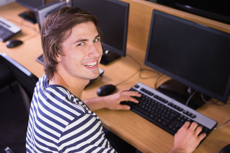 Student using computer in classroom at the universityの写真素材
