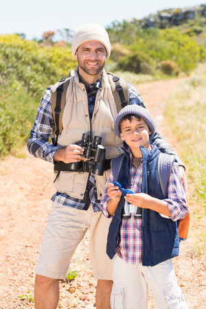 Father and son hiking in the mountains on a sunny dayの写真素材