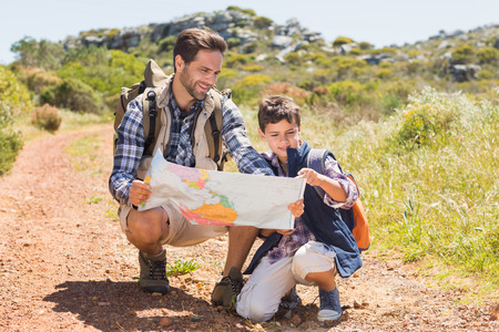 Father and son hiking in the mountains on a sunny dayの写真素材