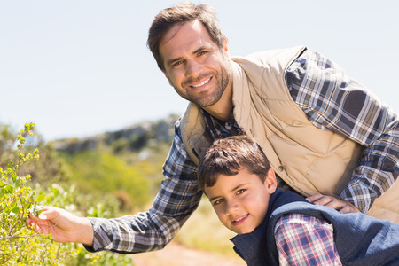 Father and son hiking in the mountains on a sunny dayの写真素材