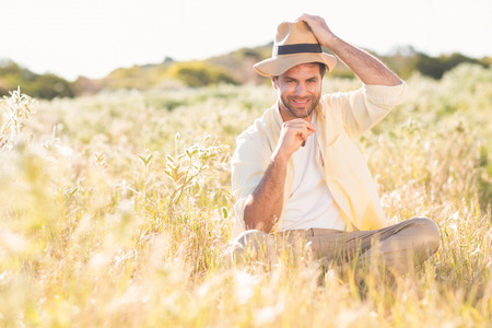 Happy man smiling at camera on a sunny dayの写真素材