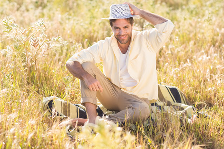 Happy man smiling at camera on a sunny dayの写真素材