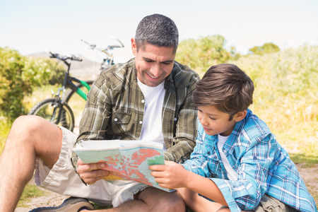 Father and son hiking in the mountains on a sunny dayの写真素材