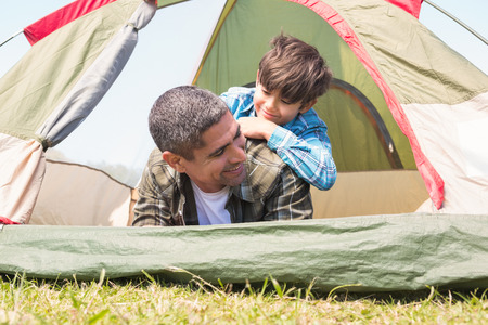 Father and son in their tent on a sunny dayの写真素材