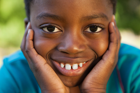 Little boy smiling at camera on a sunny dayの写真素材
