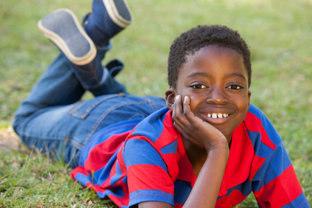 Happy little boy in the park on a sunny dayの写真素材