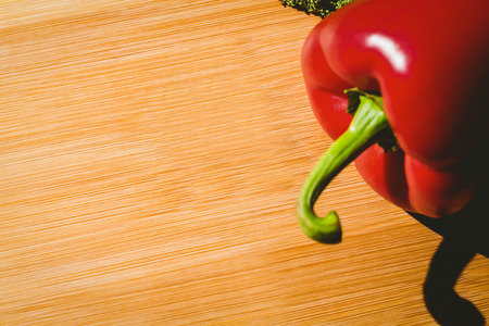 Red pepper on chopping board with copy space