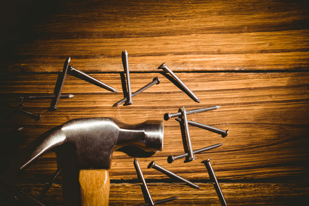 Hammer and nails laid out on table shot in studioの写真素材
