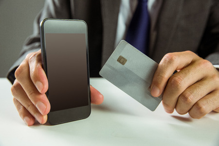 Businessman using smartphone for online shopping in close upの写真素材