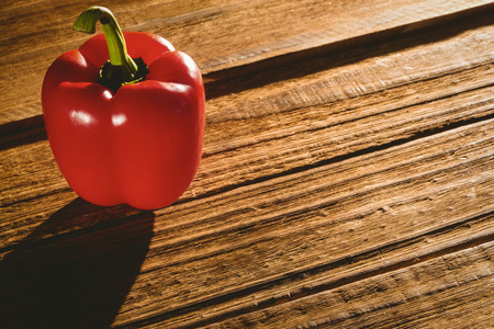 Red pepper on chopping board with copy spaceの写真素材