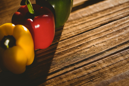 Three peppers on chopping board with copy spaceの写真素材